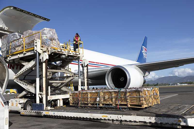 The plane is loading the cargo and preparing for air transportation.