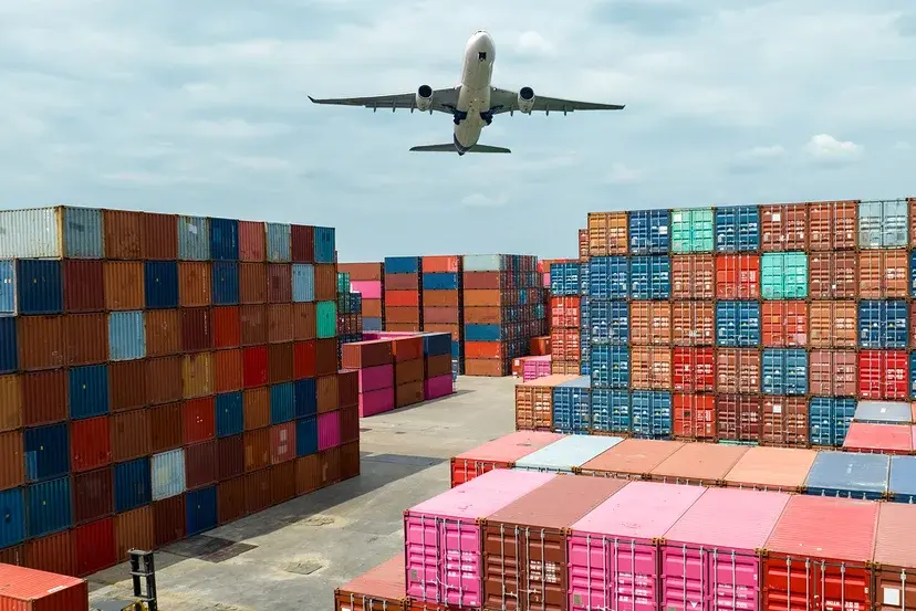 The aircraft carried out the cargo delivery by flying over the containers at the port.
